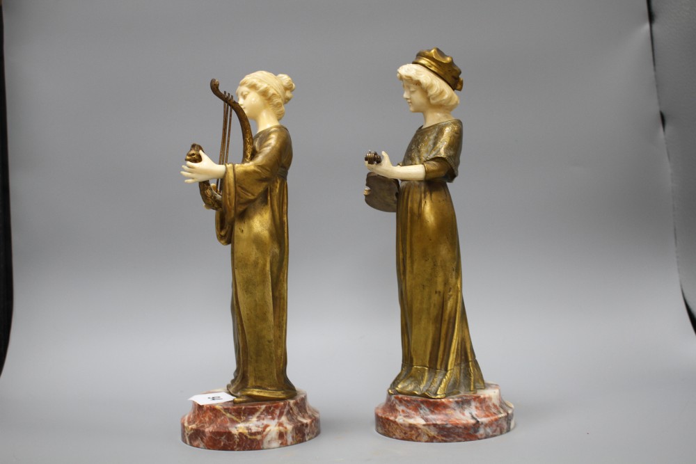 A pair of Alphonse Gori ivory and ormolu figures of medieval musicians, girl playing an Irish harp, the other plucking a violin, on mar